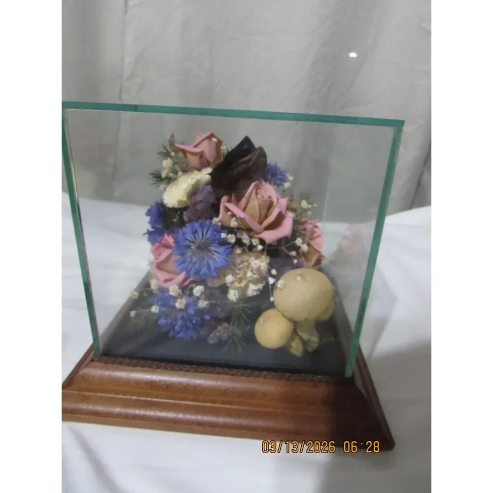 Vintage dried flower arrangement in glass with wood base butterfly mushrooms